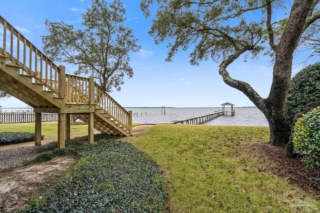 view of yard featuring a boat dock and a water view