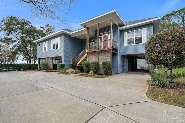 view of front of home featuring a porch and a carport