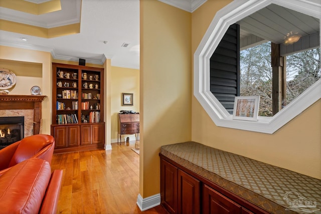 hall featuring ornamental molding and light hardwood / wood-style flooring