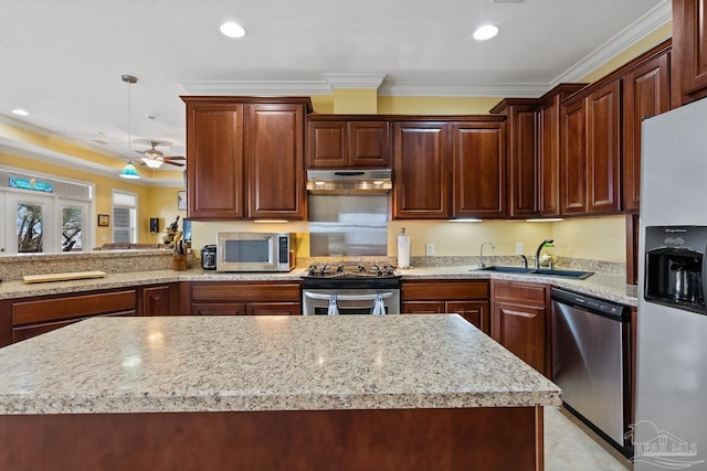 kitchen with decorative light fixtures, ceiling fan, sink, stainless steel appliances, and ornamental molding