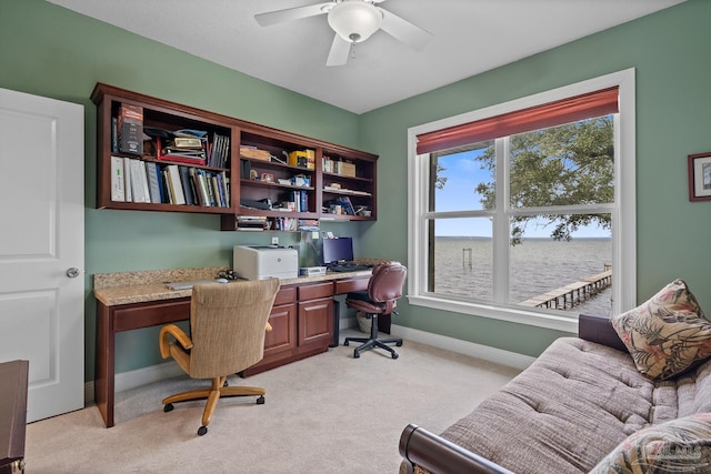 carpeted office space with ceiling fan and a wealth of natural light