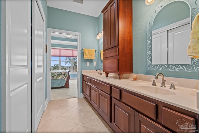 bathroom with tile patterned floors and vanity