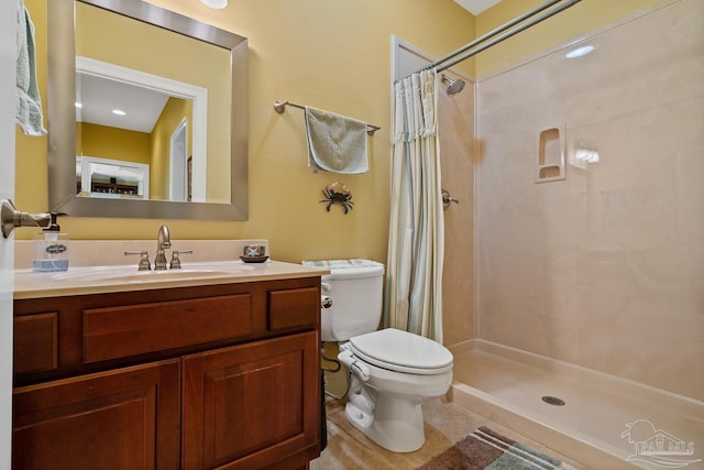 bathroom featuring toilet, vanity, and a shower with shower curtain