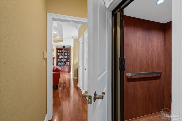 hall featuring crown molding and hardwood / wood-style flooring