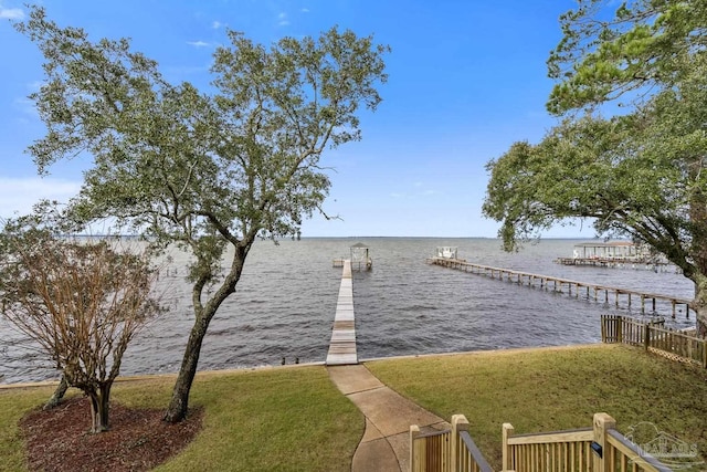 view of dock with a water view and a lawn