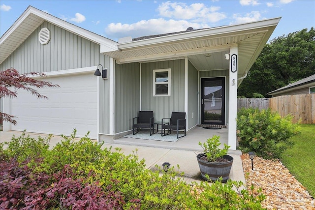 5451 Peach Dr, Pace, FL 32571 - back of house featuring board and batten siding, a porch, and an attached garage