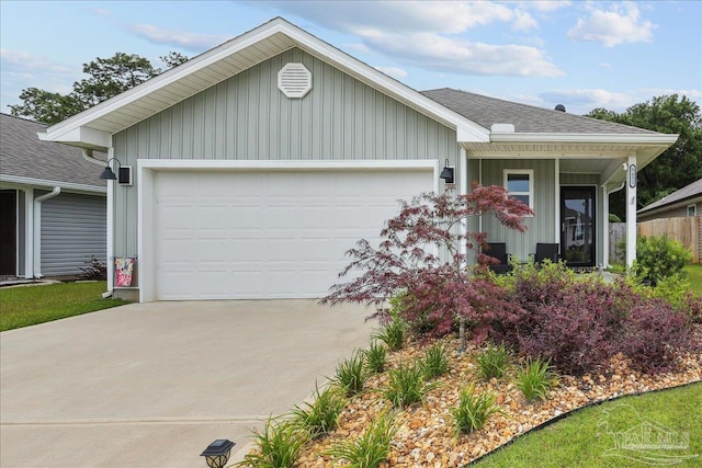 5451 Peach Dr, Pace, FL 32571 - view of front of home featuring an attached garage, driveway, a shingled roof, and board and batten siding