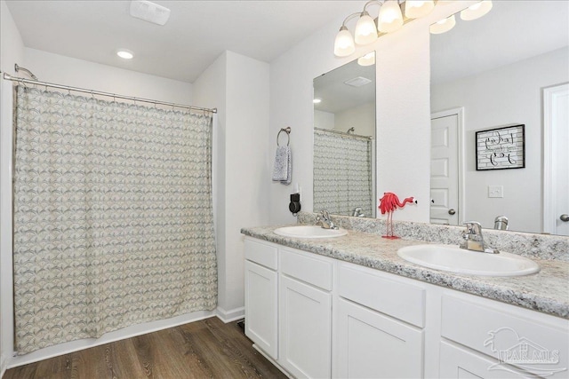 5451 Peach Dr, Pace, FL 32571 - bathroom featuring double vanity, wood finished floors, and a shower with shower curtain