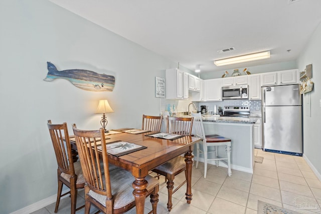 tiled dining area featuring sink