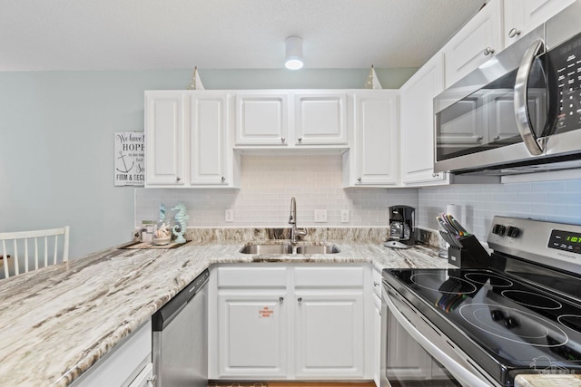 kitchen featuring sink, white cabinetry, and appliances with stainless steel finishes