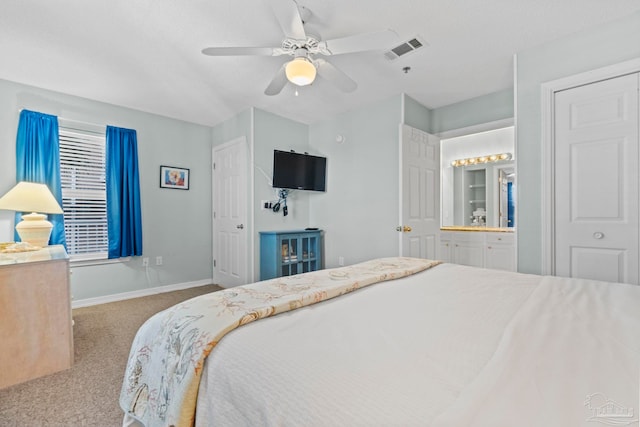 carpeted bedroom featuring ceiling fan, ensuite bathroom, and a textured ceiling