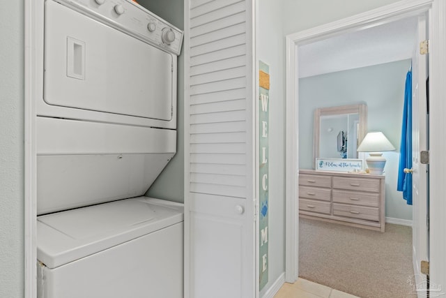 laundry area with stacked washing maching and dryer and light carpet