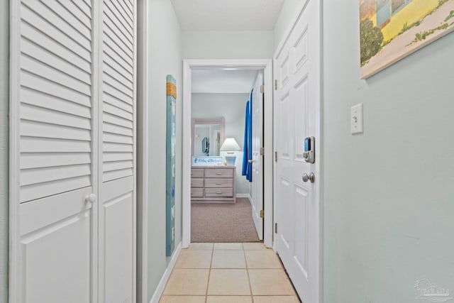 hall featuring a textured ceiling and light carpet