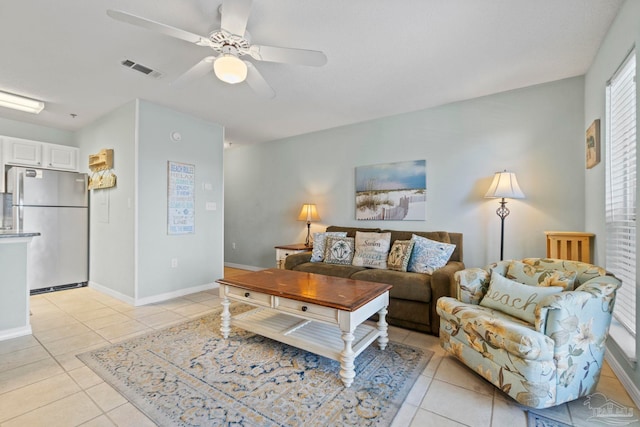 tiled living room with ceiling fan