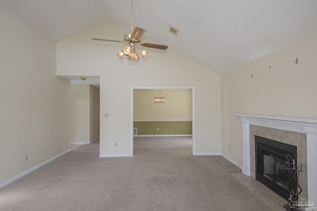 unfurnished living room with visible vents, baseboards, carpet flooring, ceiling fan with notable chandelier, and a tile fireplace