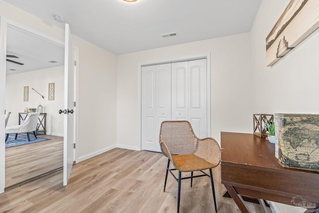 office space featuring ceiling fan and light hardwood / wood-style floors