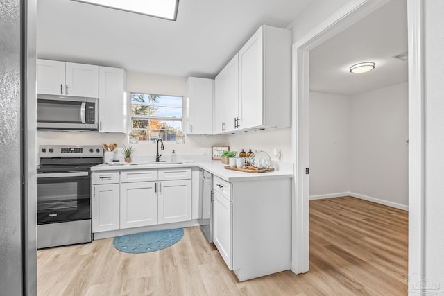 kitchen with white cabinetry, sink, and appliances with stainless steel finishes