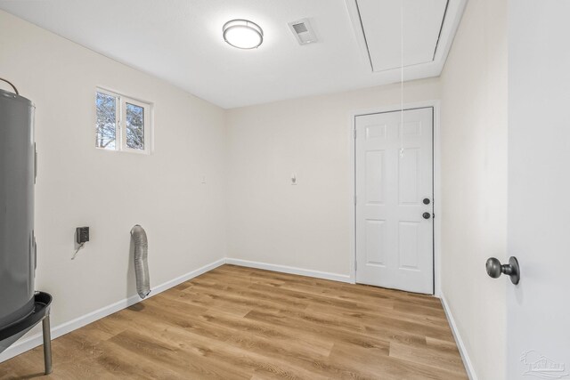 laundry room featuring wood-type flooring