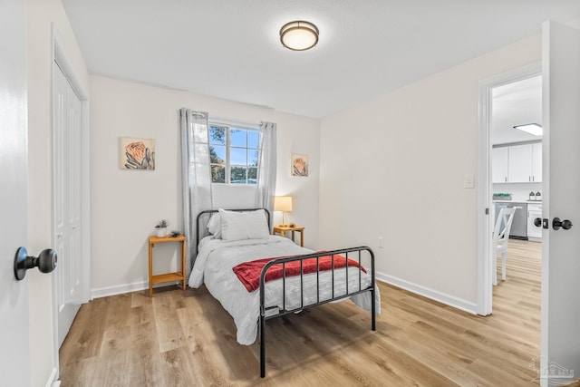 bedroom featuring light hardwood / wood-style floors and a closet