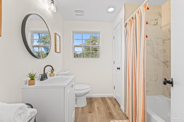 full bathroom featuring shower / bathtub combination with curtain, toilet, vanity, and hardwood / wood-style flooring