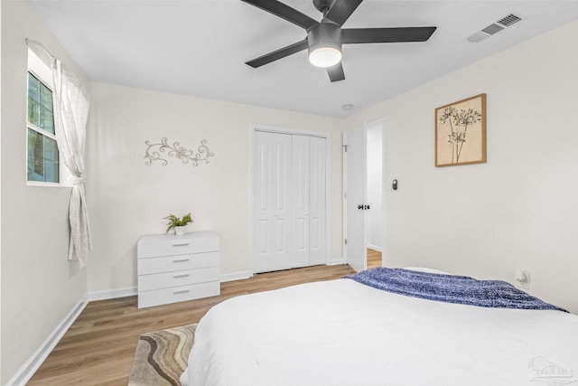 bedroom featuring ceiling fan, a closet, and light hardwood / wood-style flooring