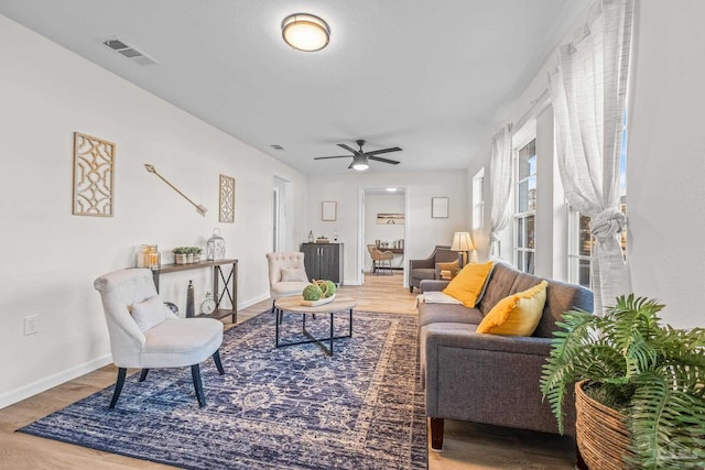 living room featuring ceiling fan and hardwood / wood-style floors