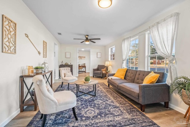 living room featuring ceiling fan and hardwood / wood-style flooring