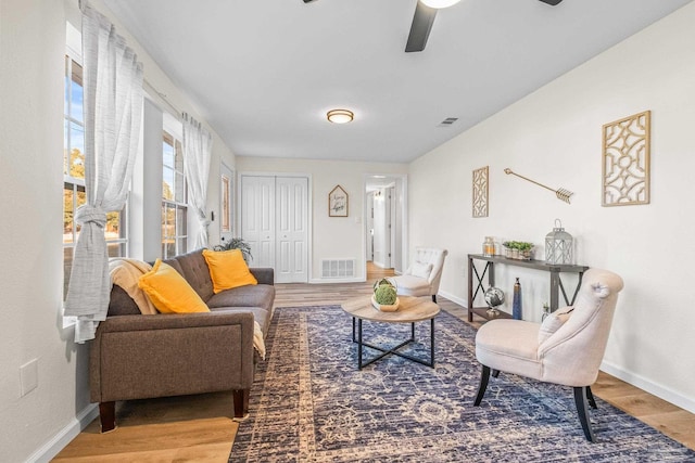 living room with wood-type flooring and ceiling fan