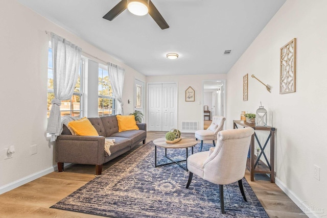 living room with hardwood / wood-style floors and ceiling fan