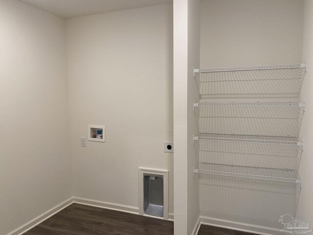 washroom featuring dark hardwood / wood-style flooring, hookup for a washing machine, and electric dryer hookup