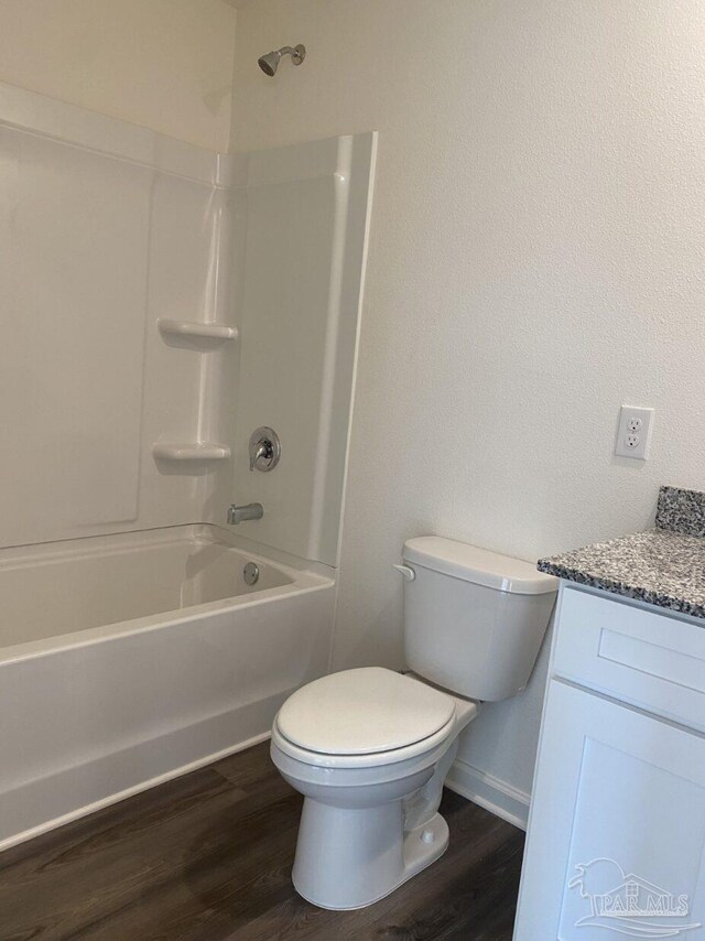 full bathroom with hardwood / wood-style floors, shower / bathing tub combination, vanity, and toilet