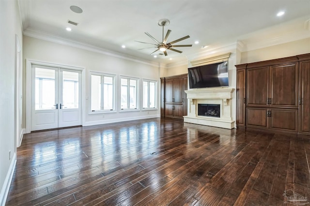 3995 W Madura Rd, Gulf Breeze, FL 32563 - unfurnished living room featuring ceiling fan, a fireplace with raised hearth, dark wood finished floors, french doors, and visible vents