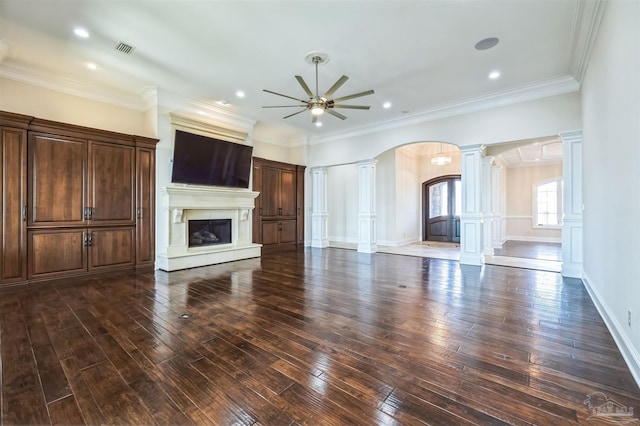 3995 W Madura Rd, Gulf Breeze, FL 32563 - unfurnished living room featuring arched walkways, hardwood / wood-style floors, a ceiling fan, ornate columns, and visible vents