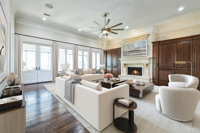 3995 W Madura Rd, Gulf Breeze, FL 32563 - living room with french doors, a lit fireplace, a ceiling fan, visible vents, and dark wood finished floors