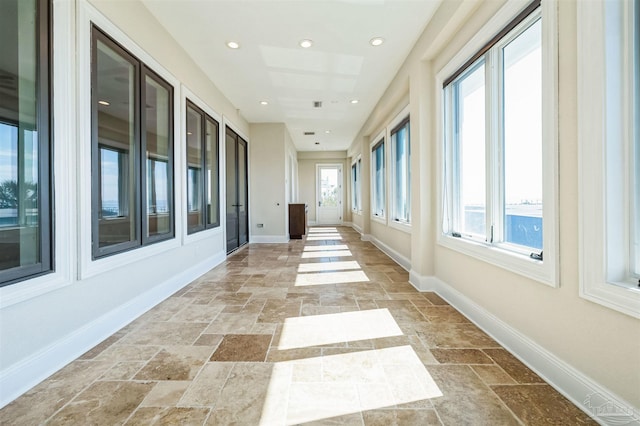 3995 W Madura Rd, Gulf Breeze, FL 32563 - hallway with baseboards, recessed lighting, and stone tile flooring