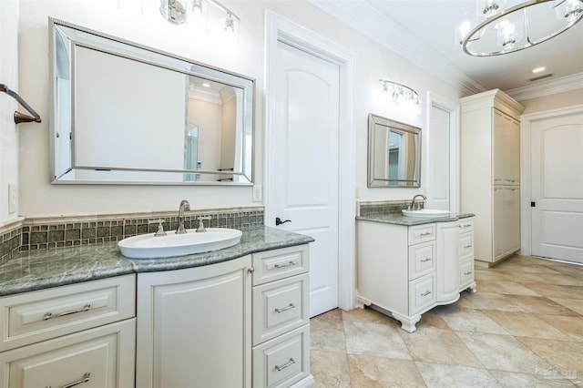 3995 W Madura Rd, Gulf Breeze, FL 32563 - full bath featuring two vanities, a notable chandelier, ornamental molding, and a sink