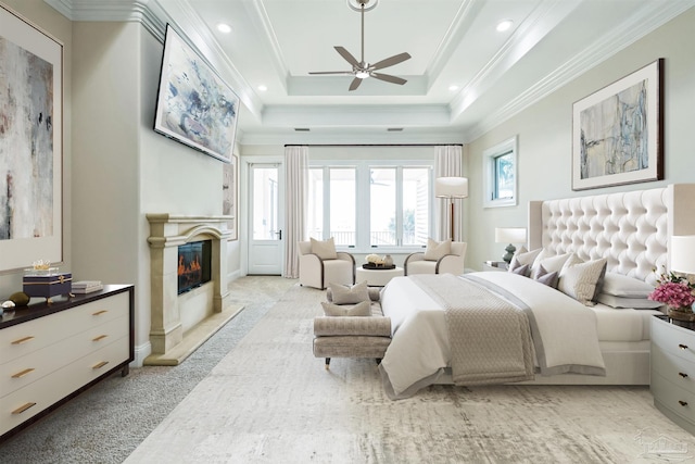 3995 W Madura Rd, Gulf Breeze, FL 32563 - bedroom featuring access to exterior, a raised ceiling, a glass covered fireplace, ornamental molding, and recessed lighting