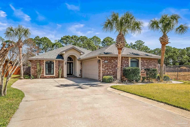 single story home featuring driveway, a garage, fence, and a front yard