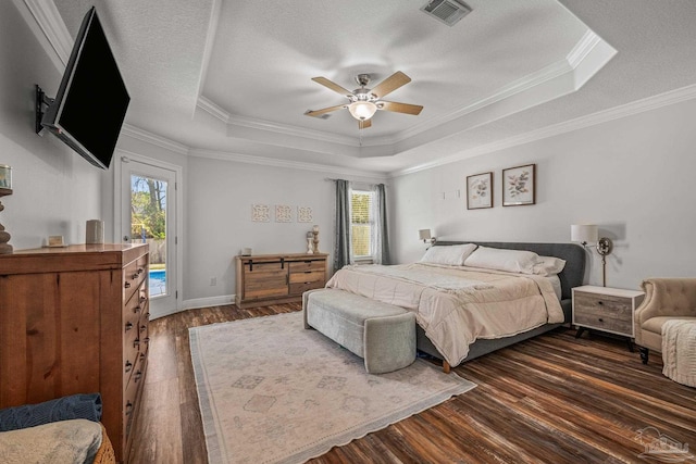 bedroom with access to outside, a raised ceiling, visible vents, and dark wood-style flooring