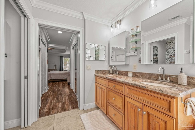 full bathroom featuring ornamental molding, a sink, ensuite bathroom, and tile patterned floors