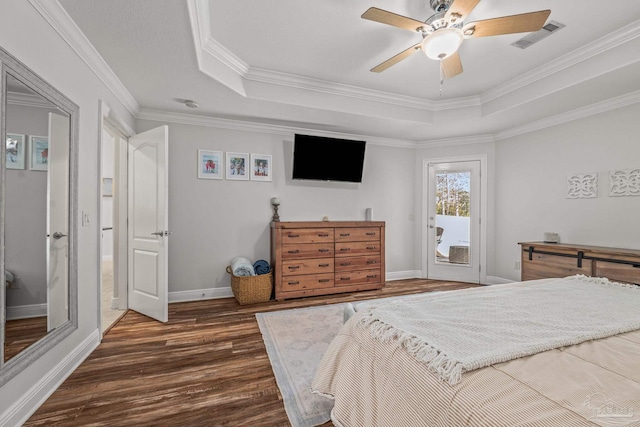 bedroom featuring access to exterior, baseboards, dark wood-style floors, and a tray ceiling