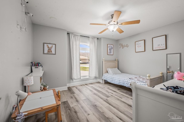 bedroom with ceiling fan, light wood-type flooring, and baseboards