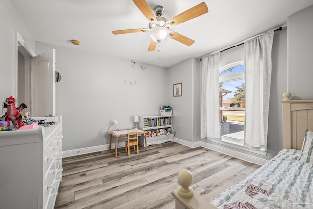 interior space featuring ceiling fan, wood finished floors, and baseboards