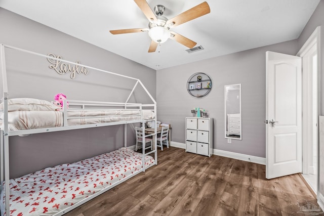 bedroom featuring a ceiling fan, baseboards, visible vents, and wood finished floors