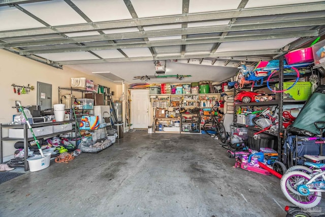 garage featuring electric panel and a garage door opener