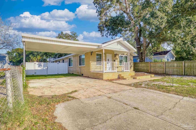 view of front of home featuring covered porch and a carport