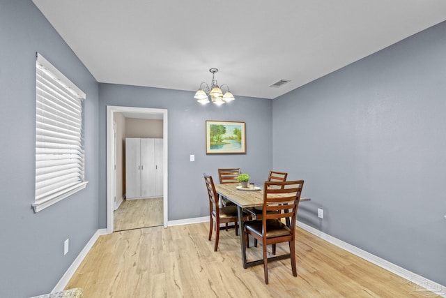 dining space featuring a chandelier and light hardwood / wood-style floors