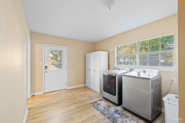 laundry area featuring separate washer and dryer and light wood-type flooring