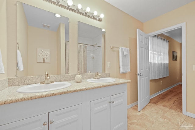 bathroom with hardwood / wood-style flooring, vanity, and a shower with shower curtain