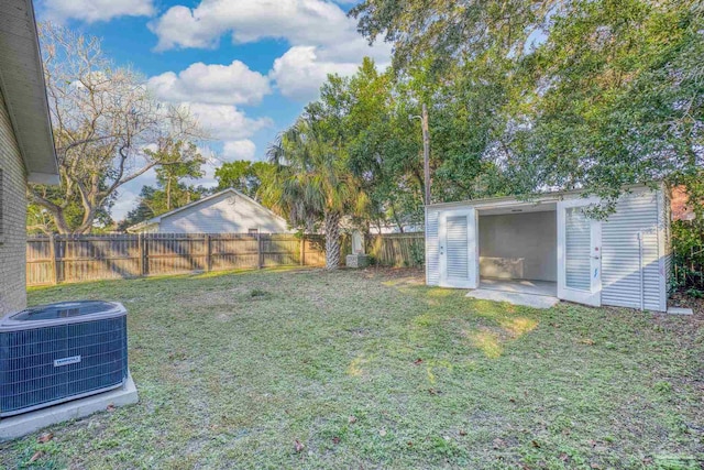 view of yard featuring an outbuilding and central AC